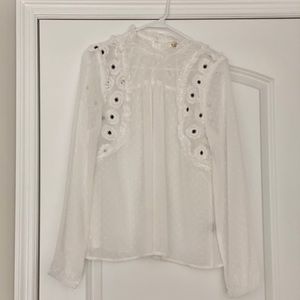White swiss dot blouse with floral embellishments